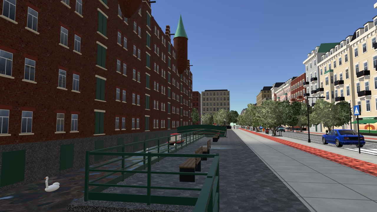 The canal promenade with swans and the brick warehouses