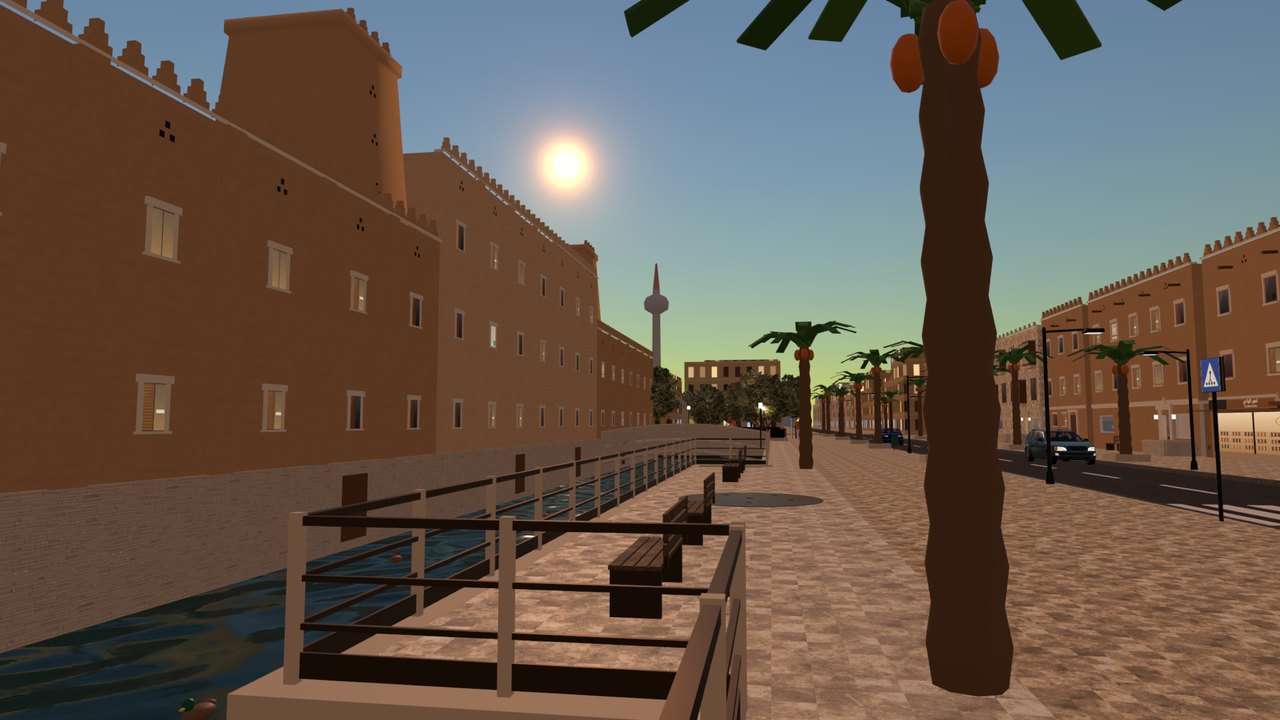 The canal promenade with swans and the brick warehouses